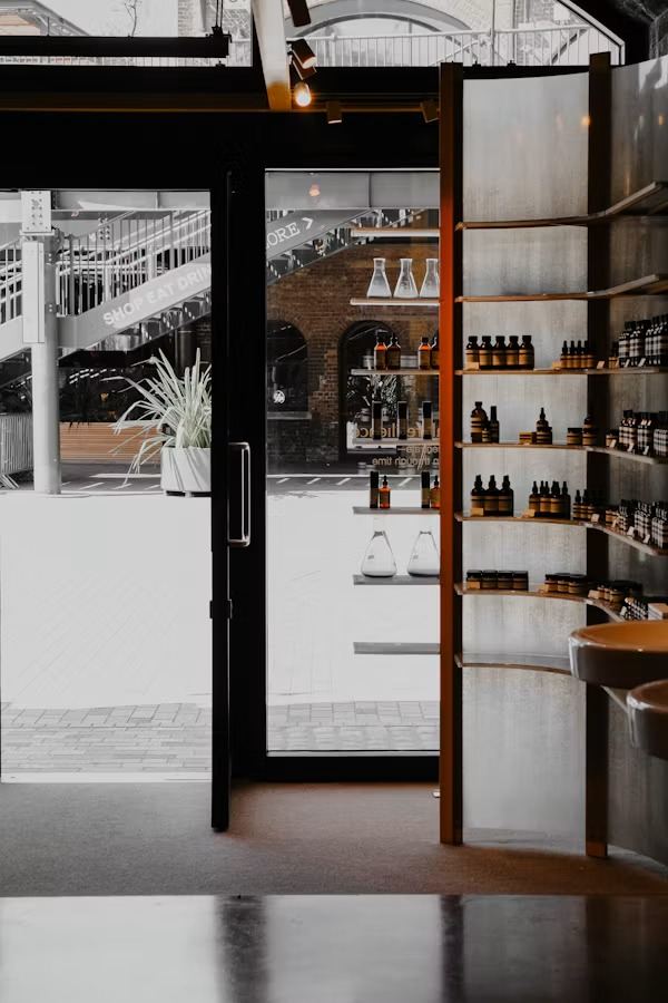 A minimal beauty boutique with amber bottles on shelves