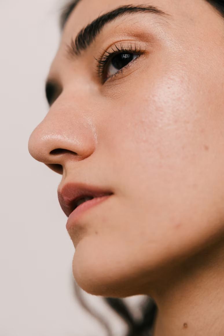 Close-up profile of a woman with glowing skin